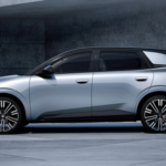 Серый кроссовер на фоне бетонной стены, вид сбоку, современный автомобильный дизайн.