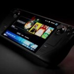 Портативная игровая консоль с экраном, черный фон.