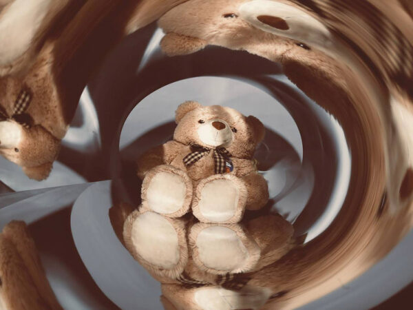 Плюшевый медведь с зеркальным эффектом, создающим иллюзию множества медвежат.