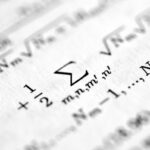 Формулы и уравнения на странице книги, крупный план, математические символы.