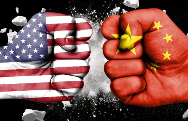 Флаги США и Китая на сжатых кулаках, символизирующих конфликт или соперничество.
