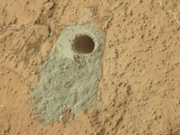 Отверстие в марсианской почве, сделанное марсоходом для исследования поверхности планеты.