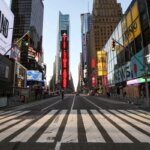 Пустая Таймс-сквер в Нью-Йорке с яркими рекламными экранами и небоскрёбами.