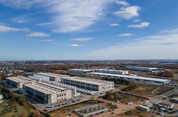 Промышленная зона с заводскими зданиями, снятая с высоты, ясное небо.