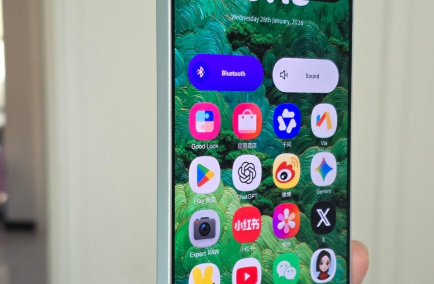 Современный смартфон с зелеными обоями и яркими иконками приложений на экране.