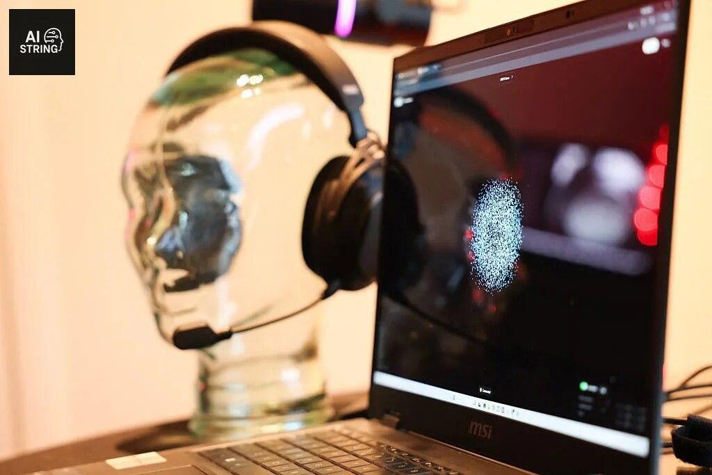 Наушники на стеклянной голове рядом с ноутбуком MSI на рабочем столе.