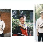 Выпускник университета с дипломом на фоне зелени и кирпичной стены.