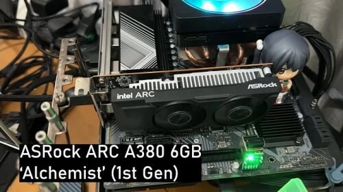 Графическая карта ASRock ARC A380 6GB Alchemist на материнской плате с фигуркой аниме.