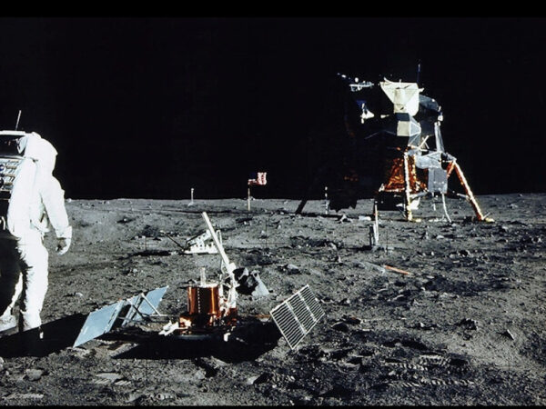 Астронавт на Луне рядом с лунным модулем и оборудованием в ходе миссии.