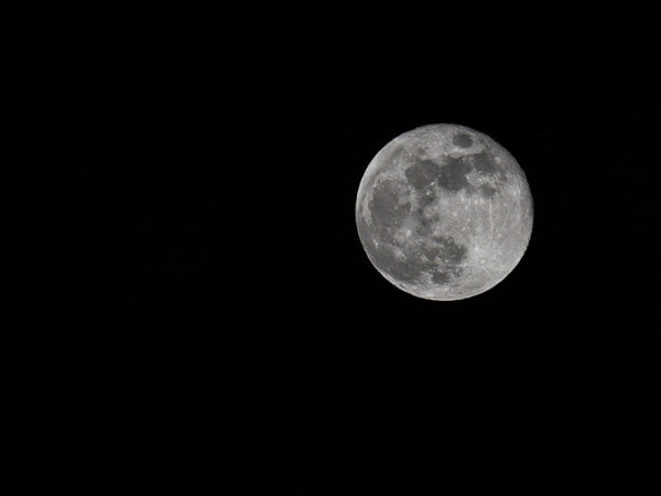 Полная луна на ночном небе, черный фон, крупный план.