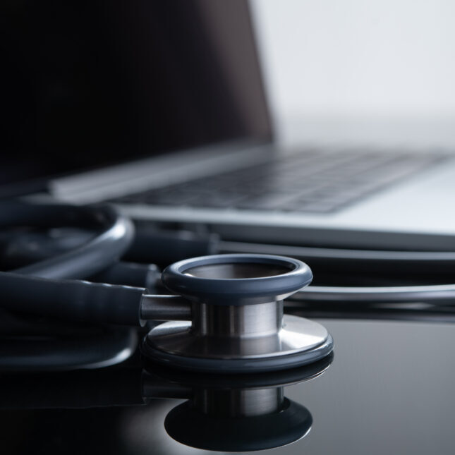 STAT+: Компания Blue Cross Blue Shield заявляет, что данные подтверждают утверждение о том, что искусственный интеллект приводит к росту медицинских расходов. 4 Стетоскоп и ноутбук на столе, символизируют цифровую медицину.