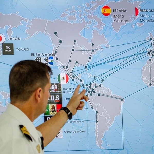 мужчина в военно-морской форме указывает на карту