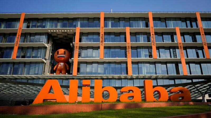 Штаб-квартира Alibaba с логотипом и фигурой на фоне современного здания.