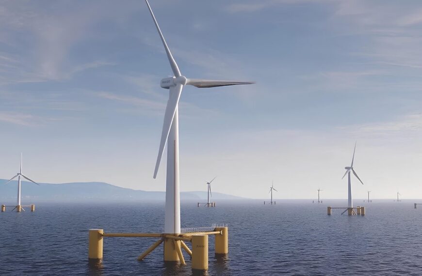 Ветряные турбины в океане на фоне гор и неба. Экологическая энергия.