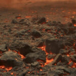 Извержение вулкана: лава и дымящиеся камни на поверхности, горячий рельеф.