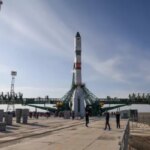 Ракета на стартовой площадке космодрома под голубым небом перед запуском в космос.