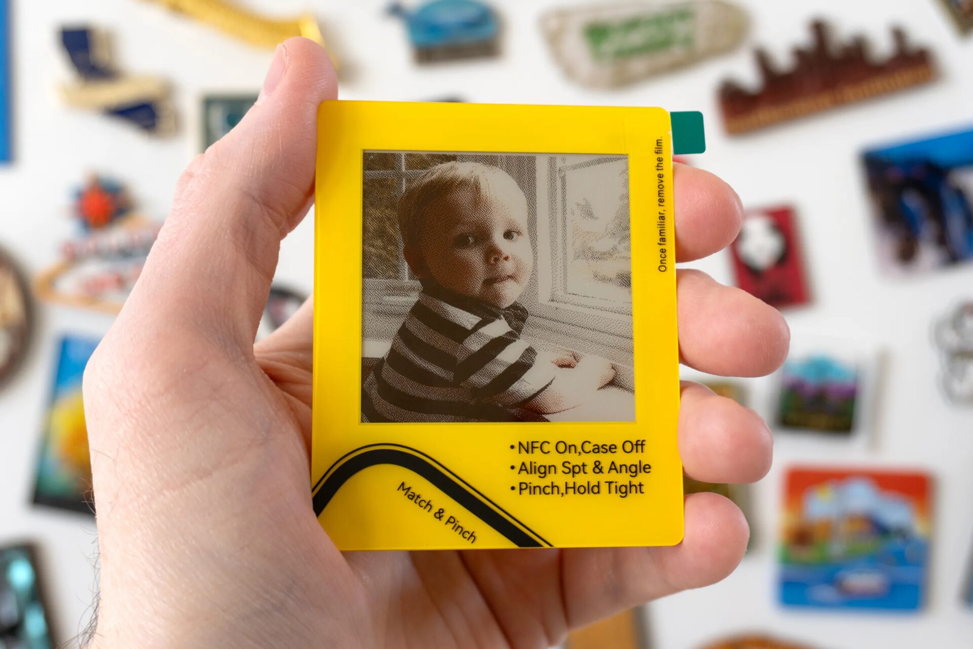 A person holds a VidaBay Snap magnetic photo frame with its screen protector still applied.
